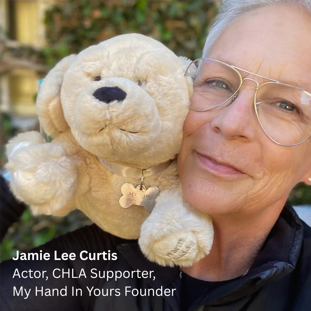 Jamie Lee Curtis holding a My Paw In Yours puppy, promoting a partnership with Children’s Hospital Los Angeles.