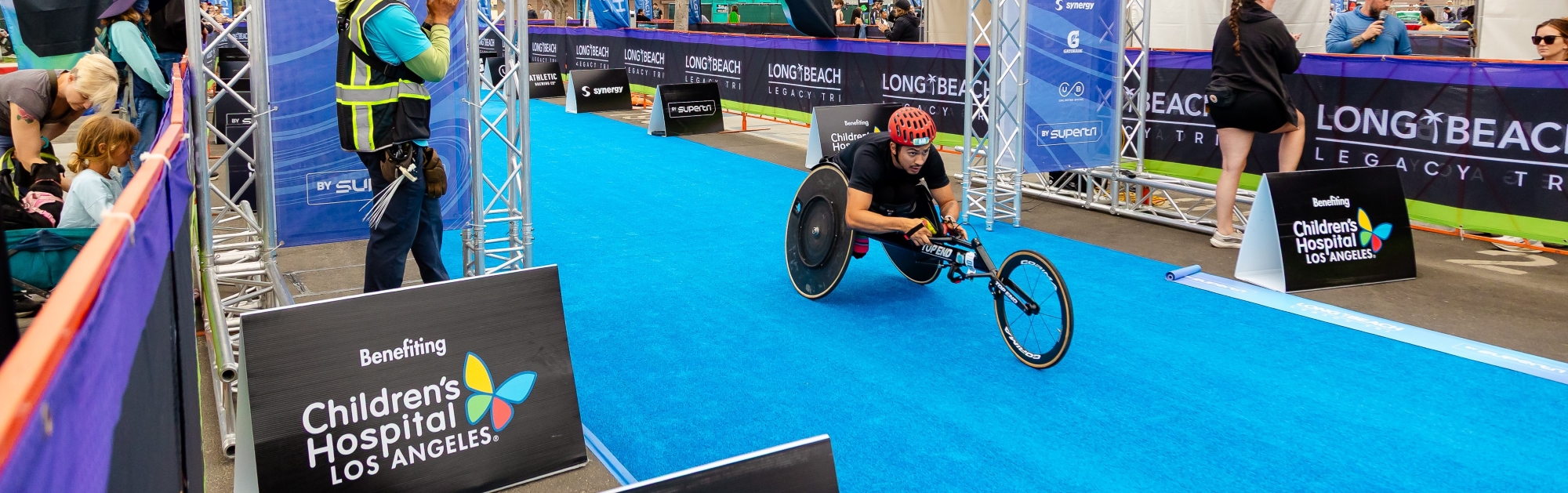 Image of racer kneeling by bike rack